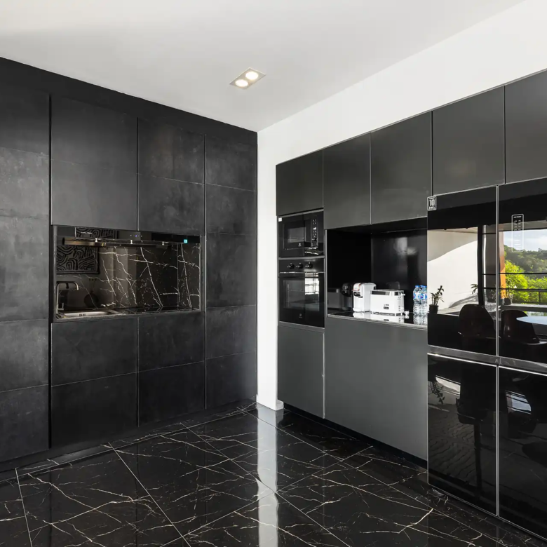 Villa Yin Kamala Headland sleek black kitchen with premium appliances