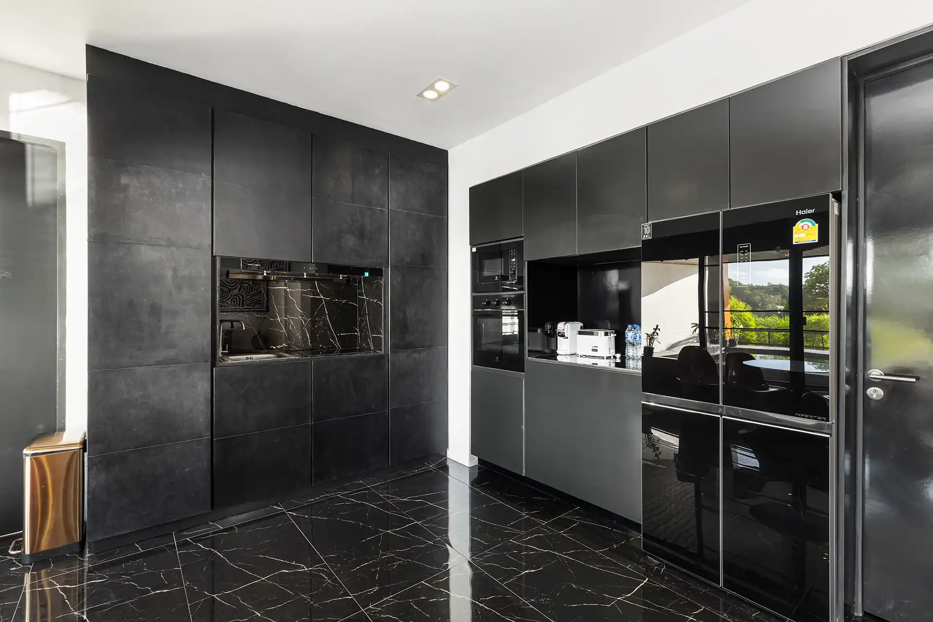 Villa Yin Kamala Headland sleek black kitchen with premium appliances