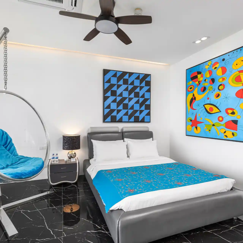 Villa Yin Kamala Headland modern guest bedroom with art and bubble chair