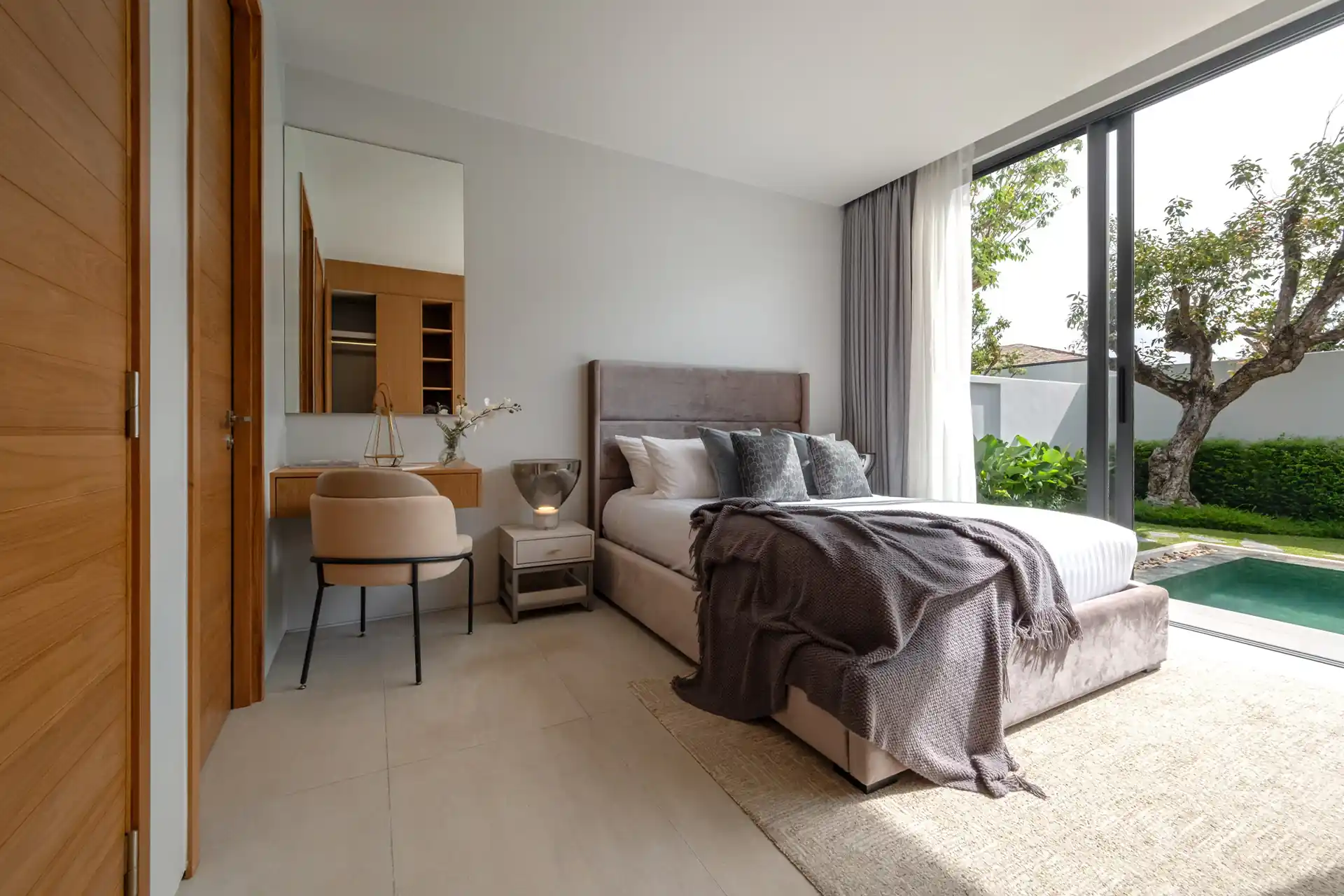 Botanica Four Season Thalang cozy bedroom with vanity desk and pool access