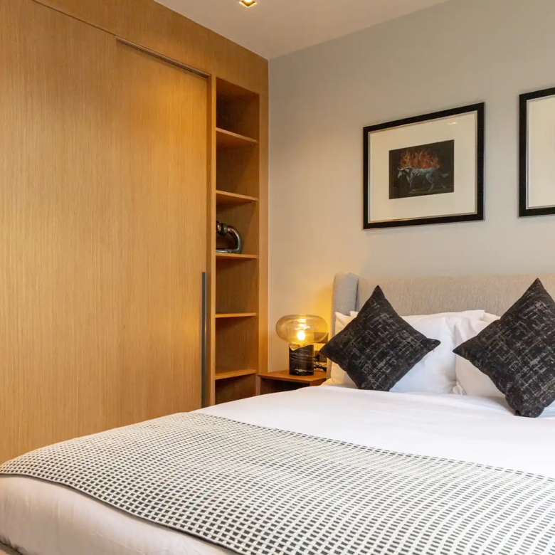 Botanica Four Season Thalang stylish guest bedroom with sliding wardrobe and shelving