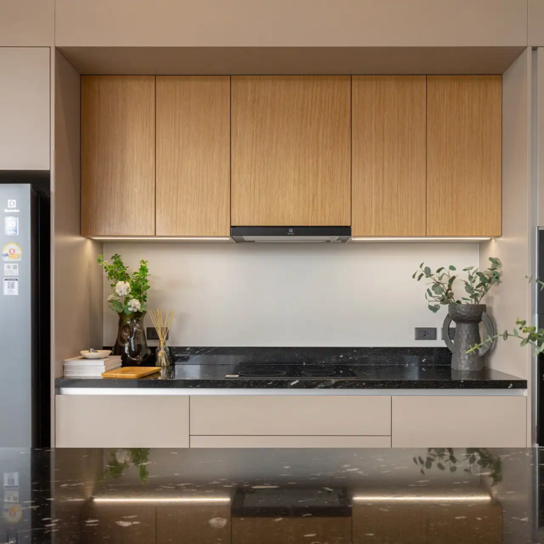 Botanica Four Season Thalang modern kitchen with wood cabinets and black countertop