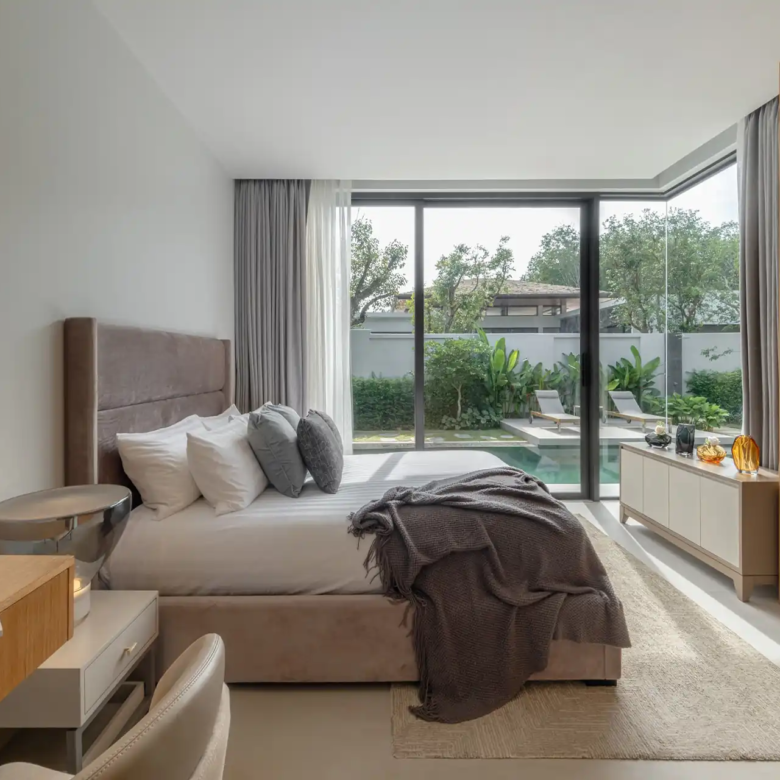 Botanica Four Season Thalang serene bedroom with full-height windows to pool