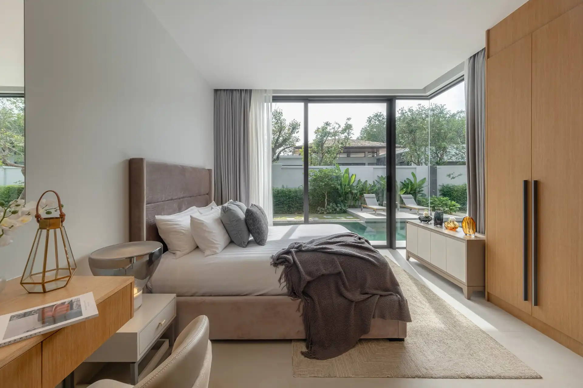 Botanica Four Season Thalang serene bedroom with full-height windows to pool