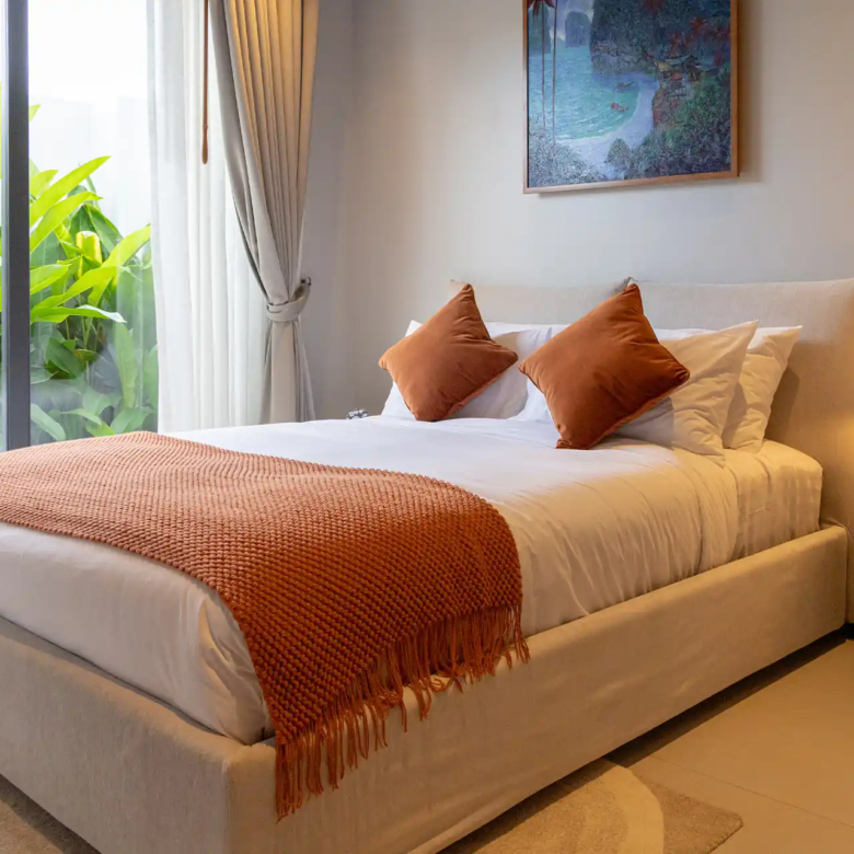 Botanica Four Season Thalang cozy bedroom with tropical garden view and soft lighting