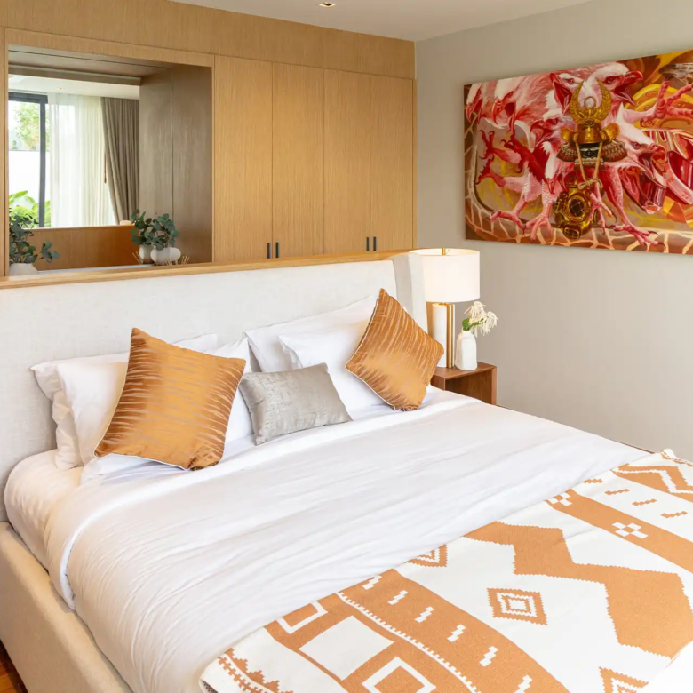 Botanica Four Season Thalang warm-toned bedroom with large feature wall artwork