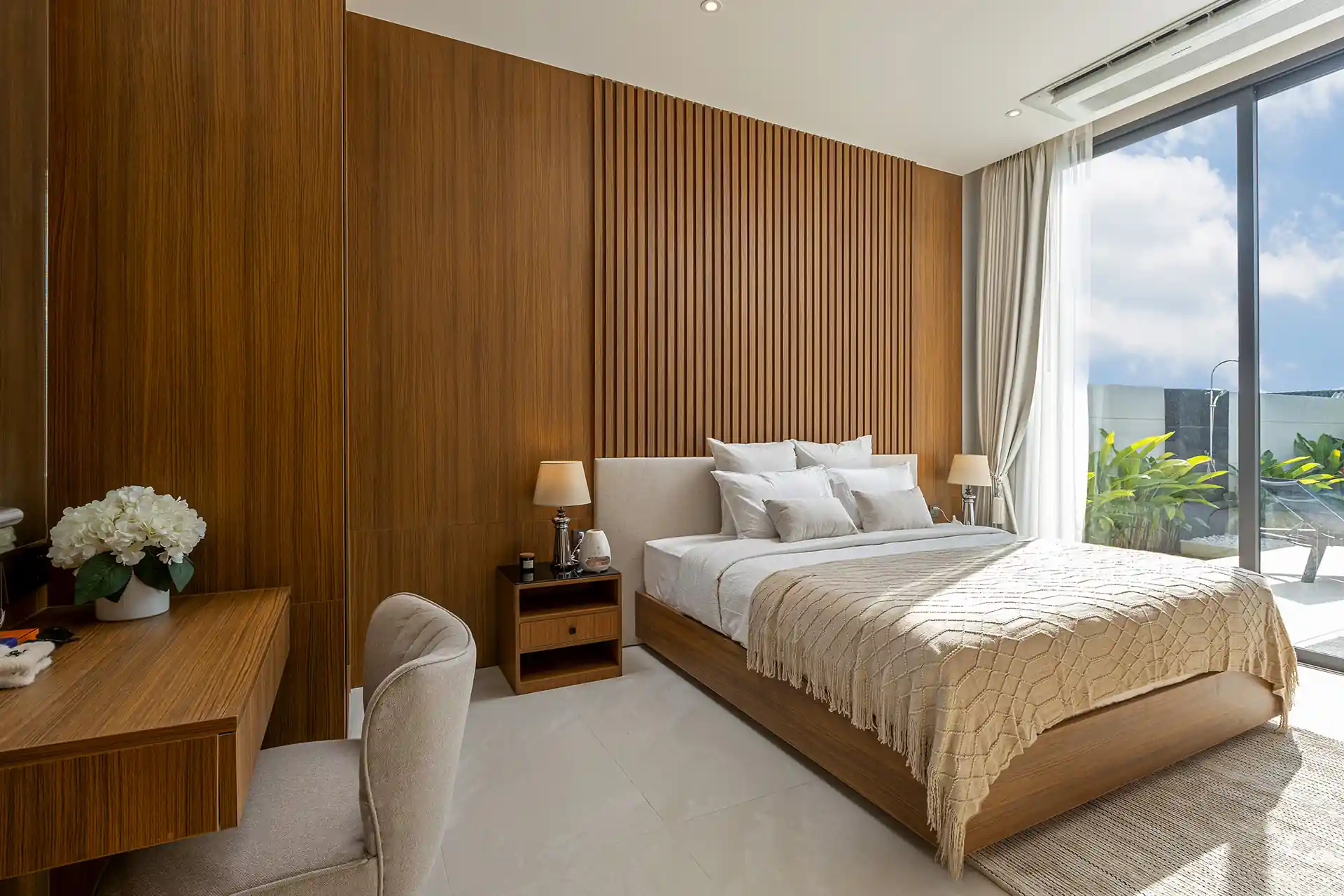 Mouana Cherng Talay main bedroom with warm wood wall and terrace
