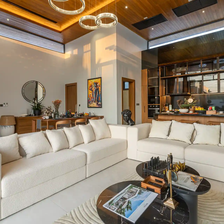 Mouana Cherng Talay designer living room with modern kitchen and high ceiling