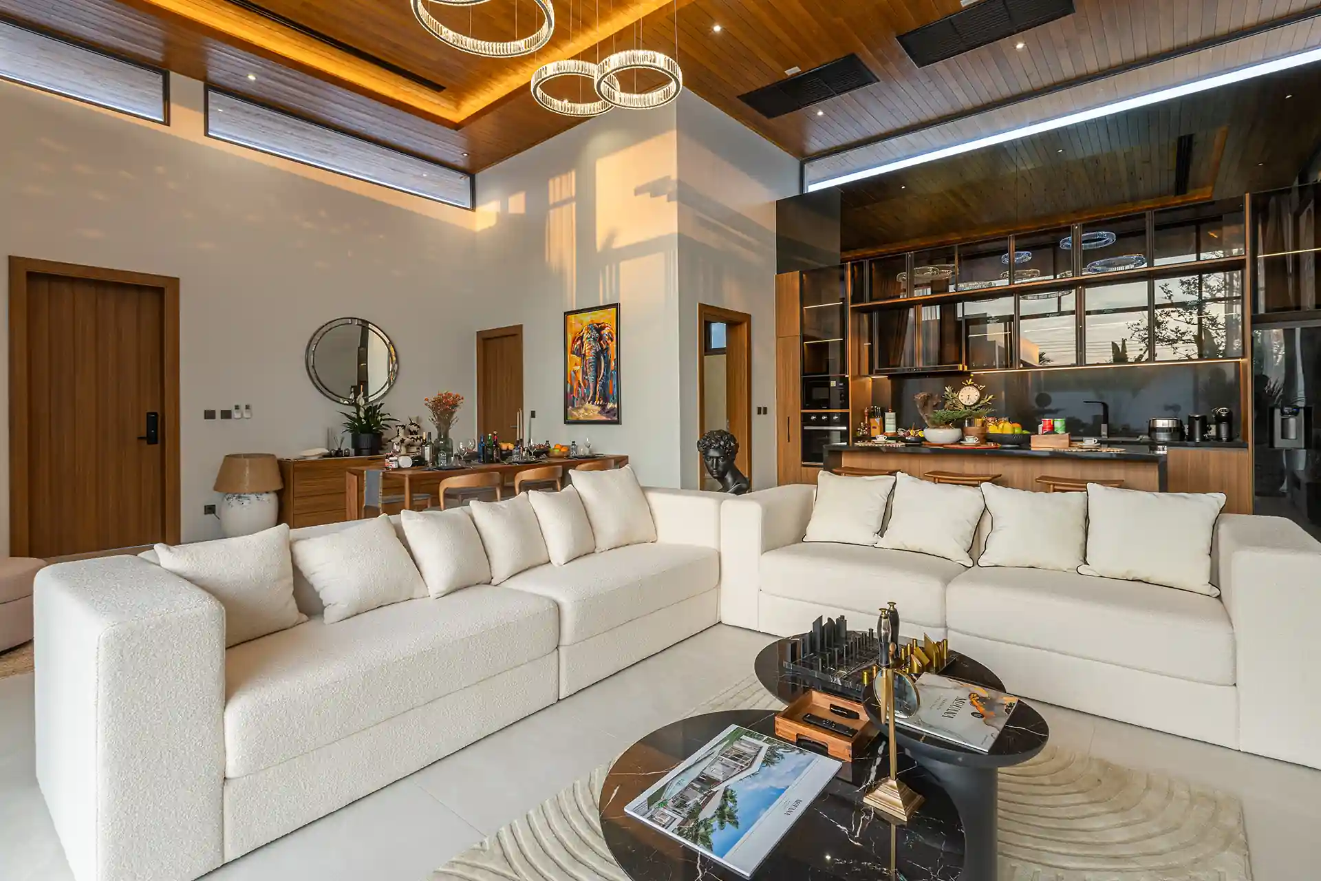 Mouana Cherng Talay designer living room with modern kitchen and high ceiling