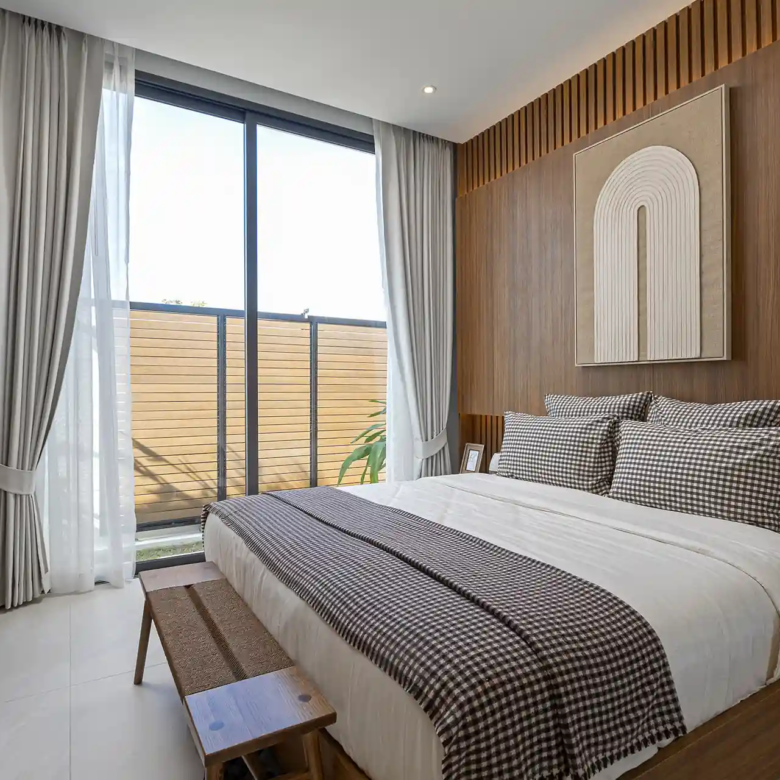 Mouana Cherng Talay cozy guest bedroom with wood feature wall