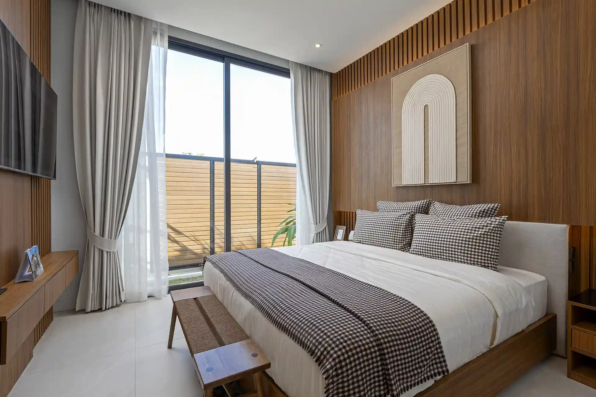Mouana Cherng Talay cozy guest bedroom with wood feature wall