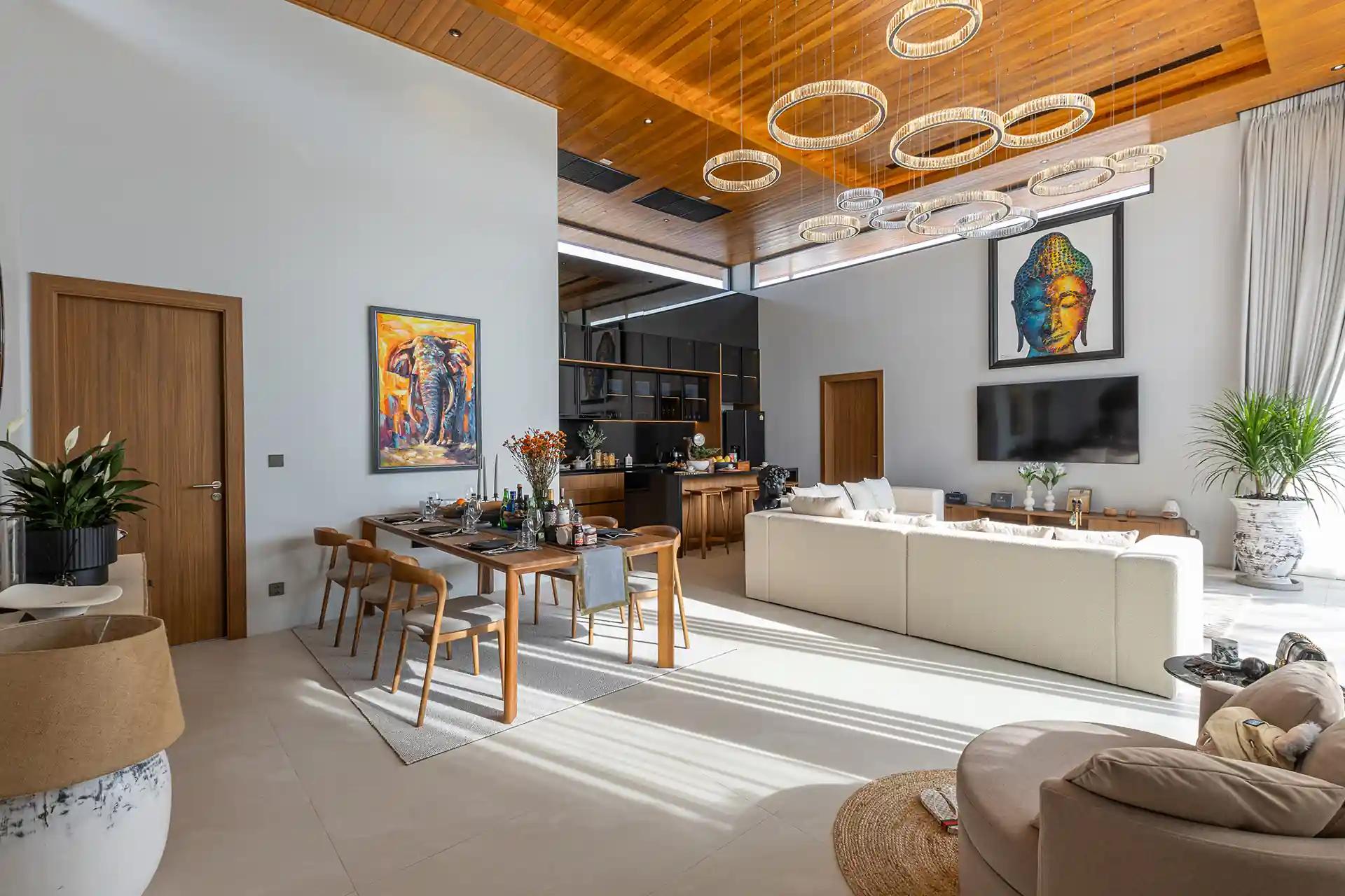 Mouana Cherng Talay open plan living and dining with statement chandeliers