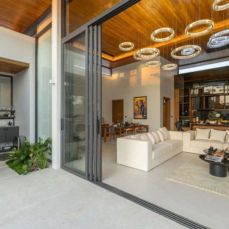 Mouana Cherng Talay open-plan living room flowing onto terrace and pool