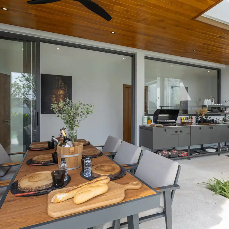 Mouana Cherng Talay covered outdoor dining pavilion with styled table setting