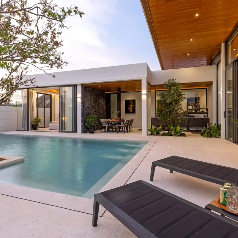 Mouana Cherng Talay pool deck with loungers, tree and outdoor dining