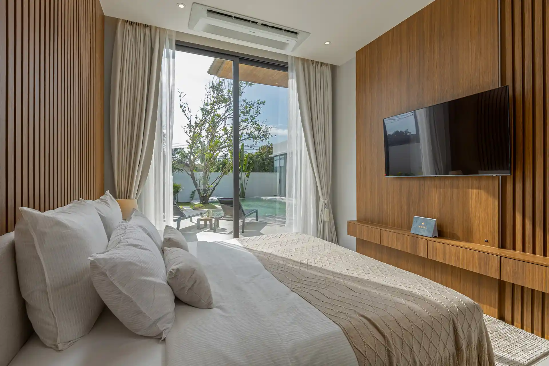 Mouana Cherng Talay bedroom opening to pool terrace and sun loungers