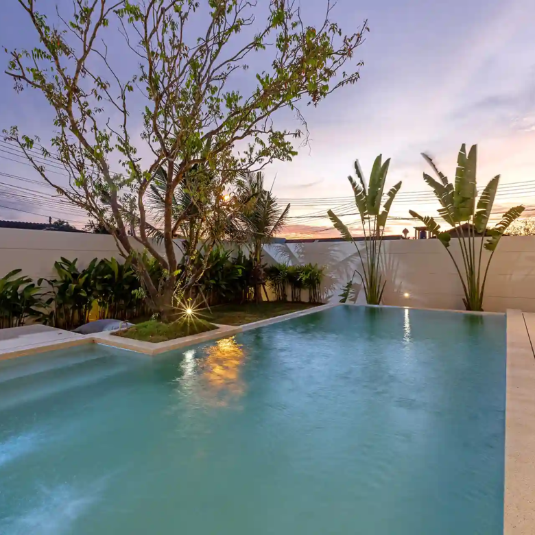 Mouana Cherng Talay pool with shallow steps, garden and evening sky