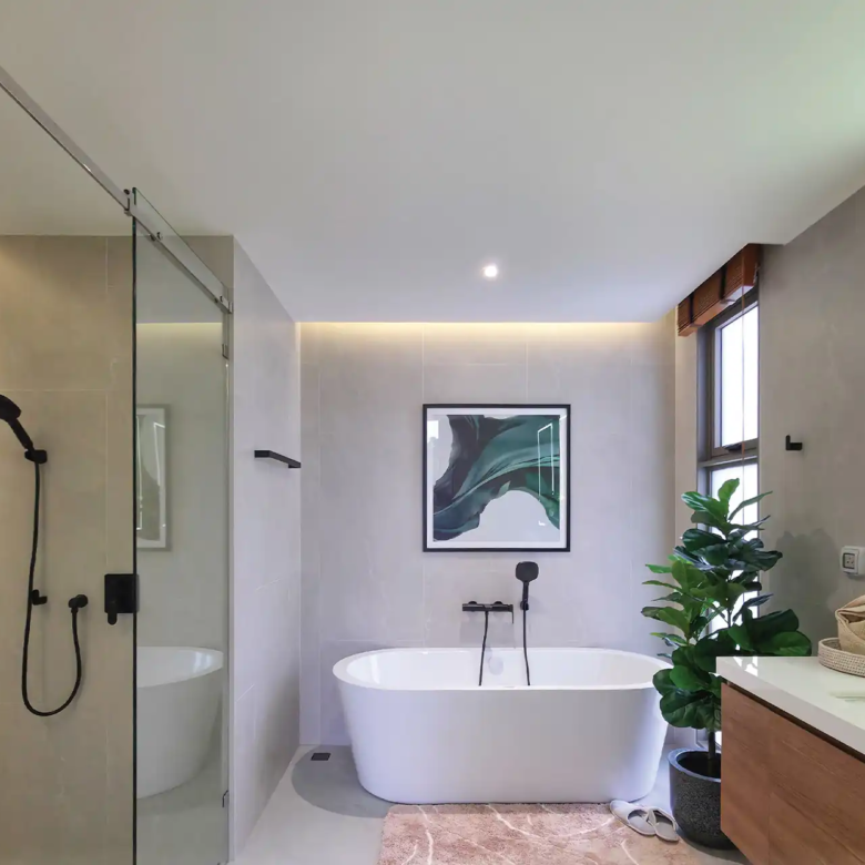 Serene Raya Bangjo bathroom with freestanding bathtub and glass shower enclosure