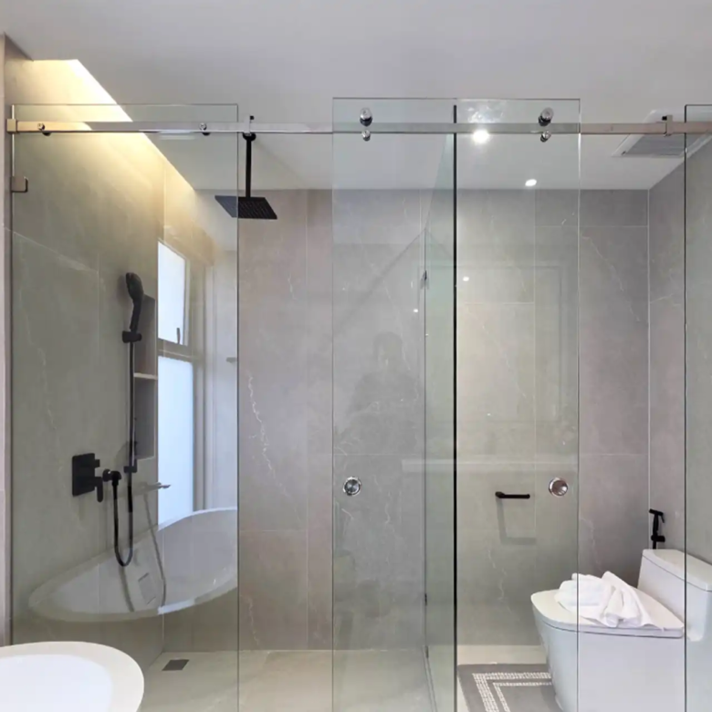 Serene Raya Bangjo bathroom with glass-enclosed shower and modern toilet
