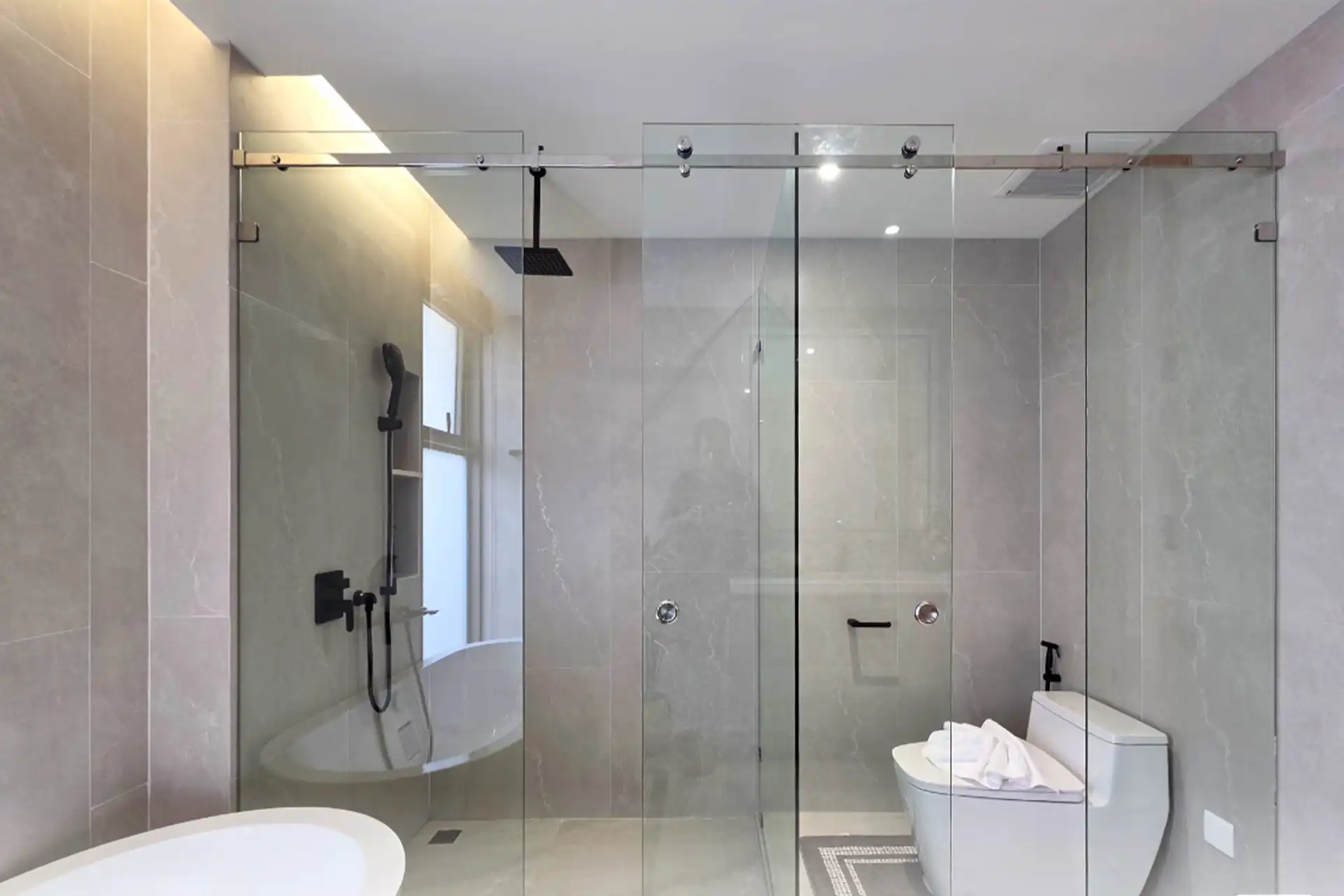 Serene Raya Bangjo bathroom with glass-enclosed shower and modern toilet