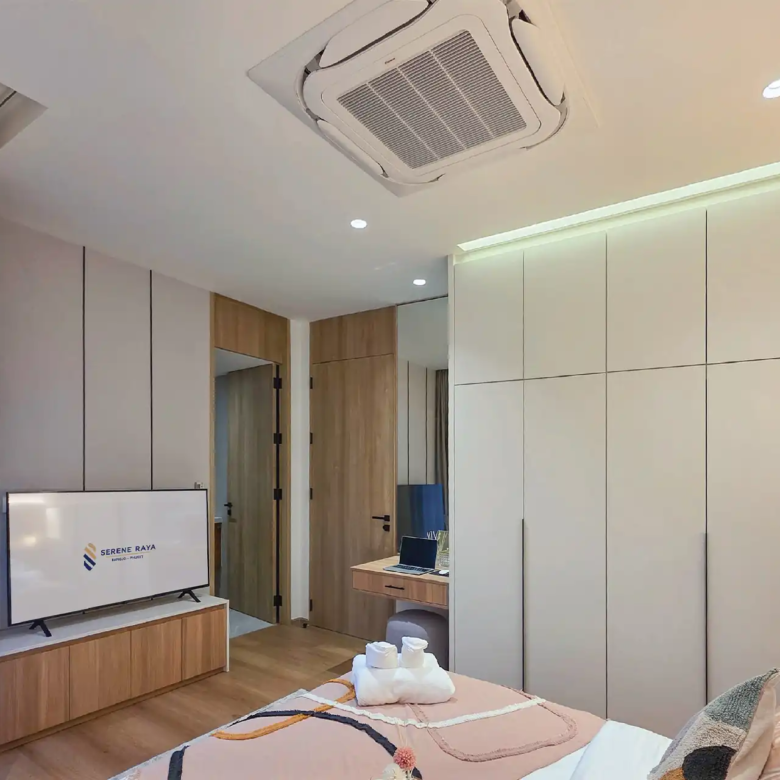 Serene Raya Bangjo guest bedroom with built-in wardrobes and TV unit