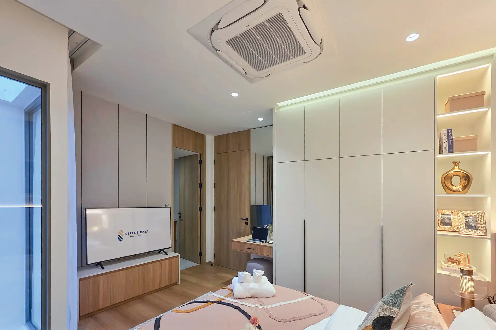 Serene Raya Bangjo guest bedroom with built-in wardrobes and TV unit