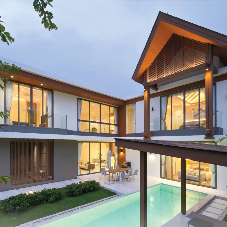 Serene Raya Bangjo L-shaped pool villa courtyard glowing at night