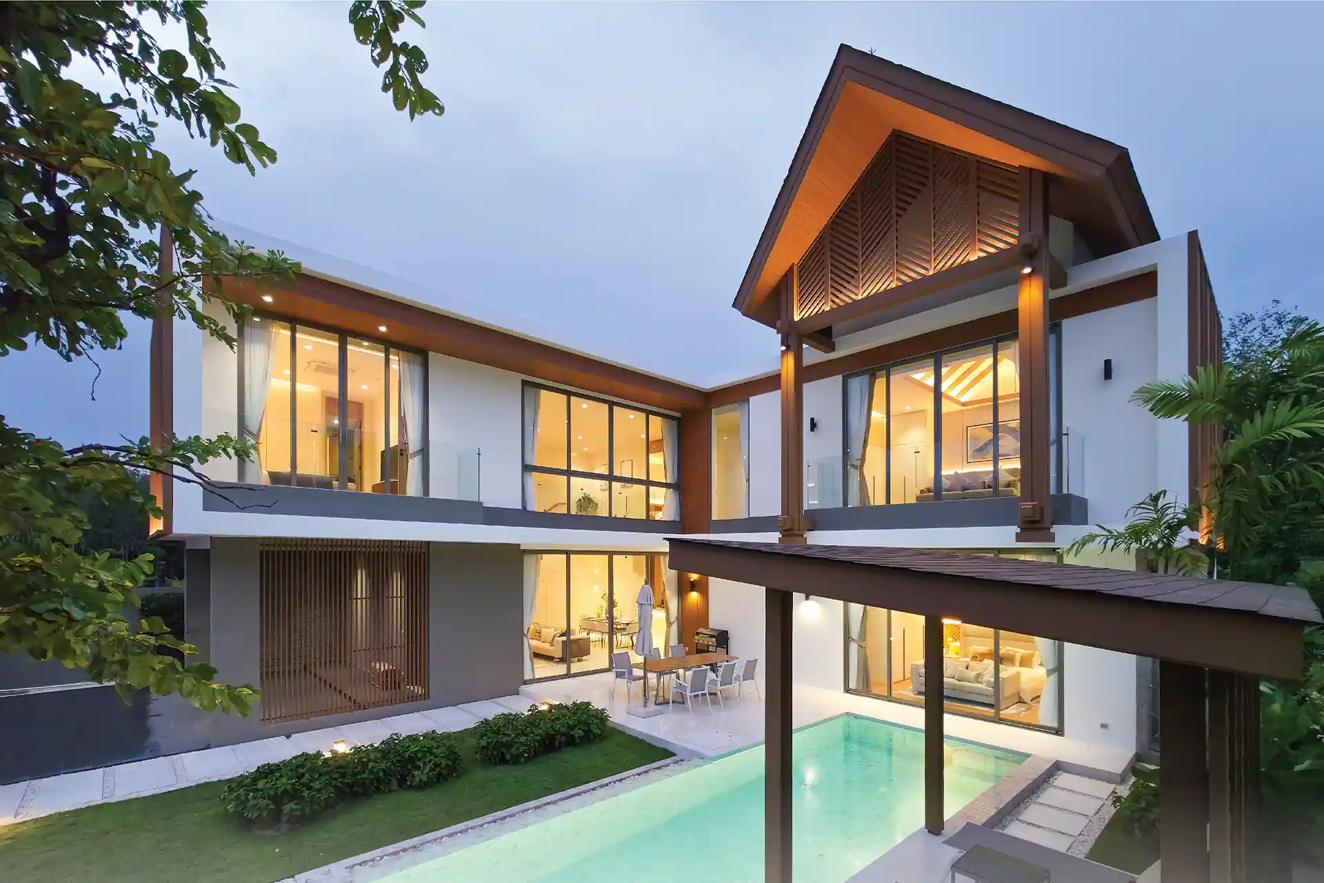 Serene Raya Bangjo L-shaped pool villa courtyard glowing at night