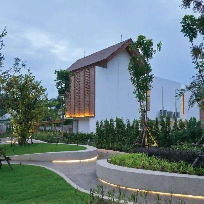 Serene Raya Bangjo landscaped rear walkway curving past trees behind villa