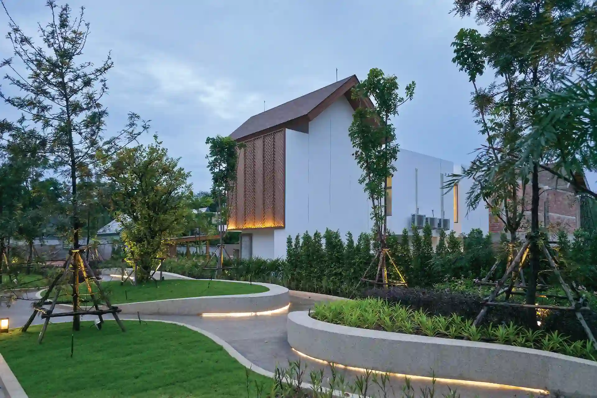 Serene Raya Bangjo landscaped rear walkway curving past trees behind villa