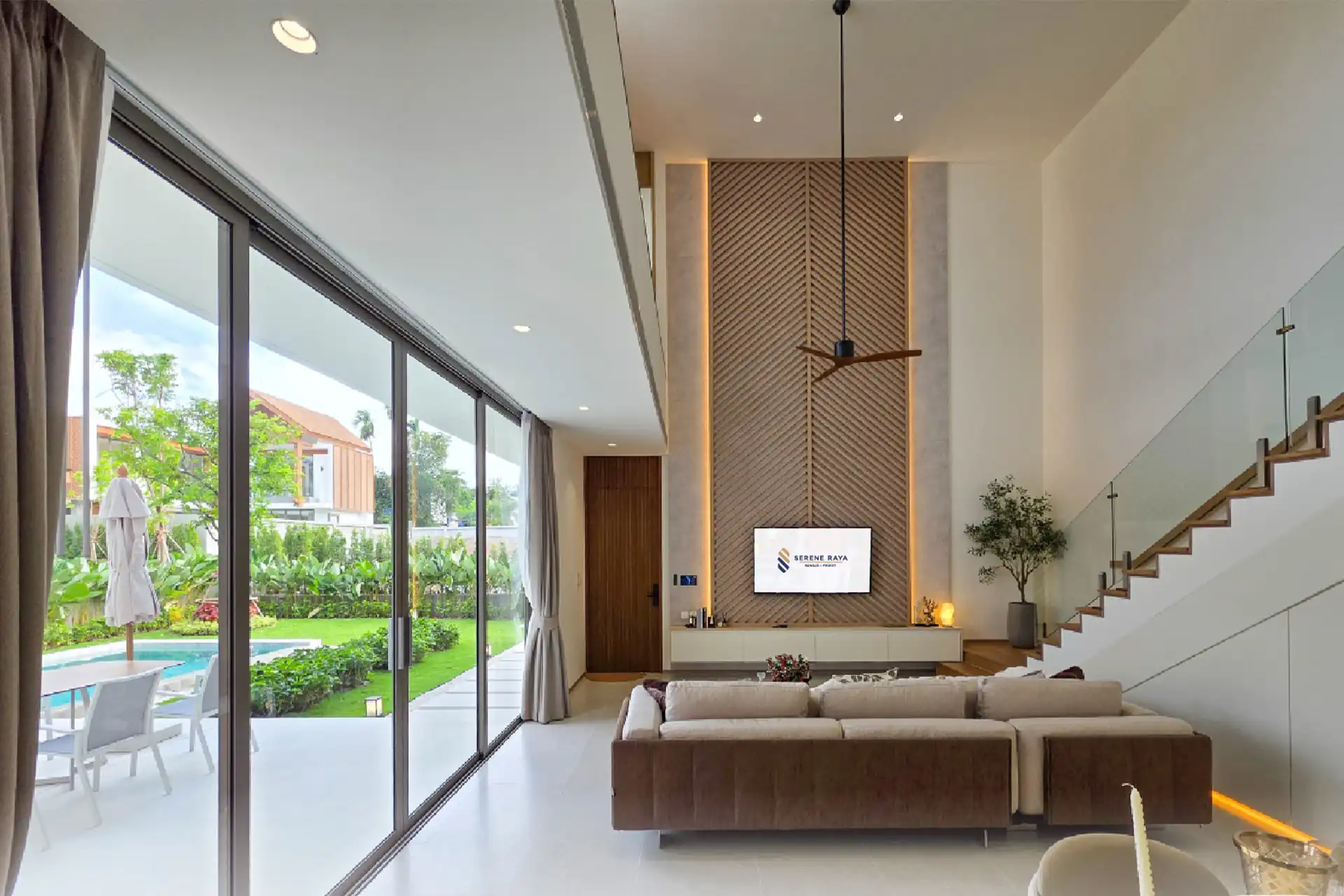 Serene Raya Bangjo living room with full-height glass to garden pool