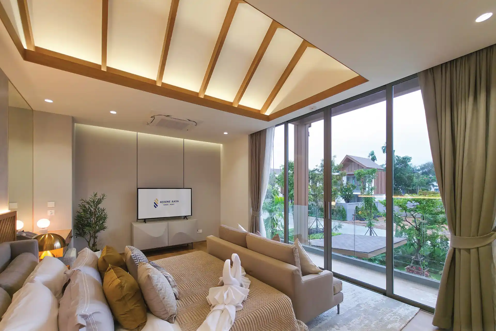 Serene Raya Bangjo master bedroom opening to balcony with garden community view