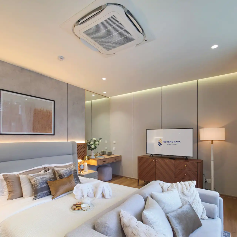 Serene Raya Bangjo master bedroom with sofa, TV and balcony view