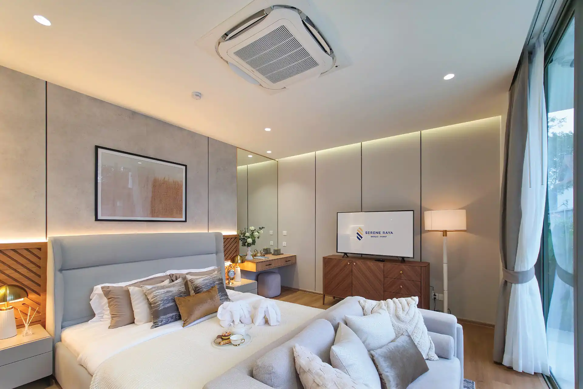 Serene Raya Bangjo master bedroom with sofa, TV and balcony view