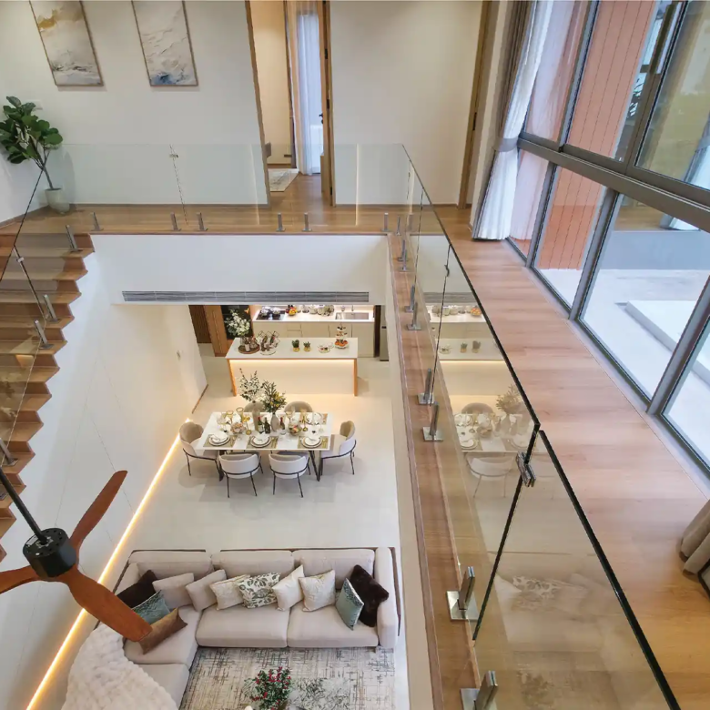 Serene Raya Bangjo mezzanine view overlooking double-volume living and dining