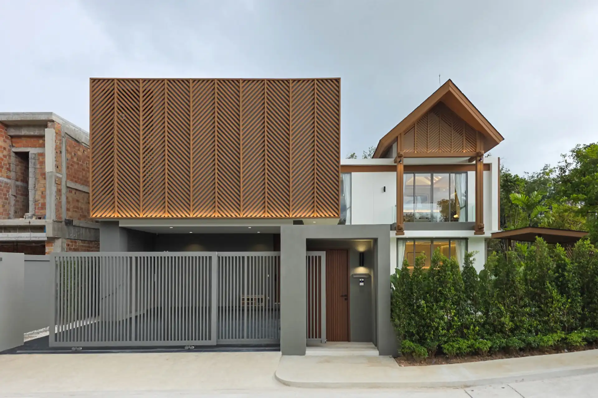 Serene Raya Bangjo contemporary street facade with gated carport and upper bedroom