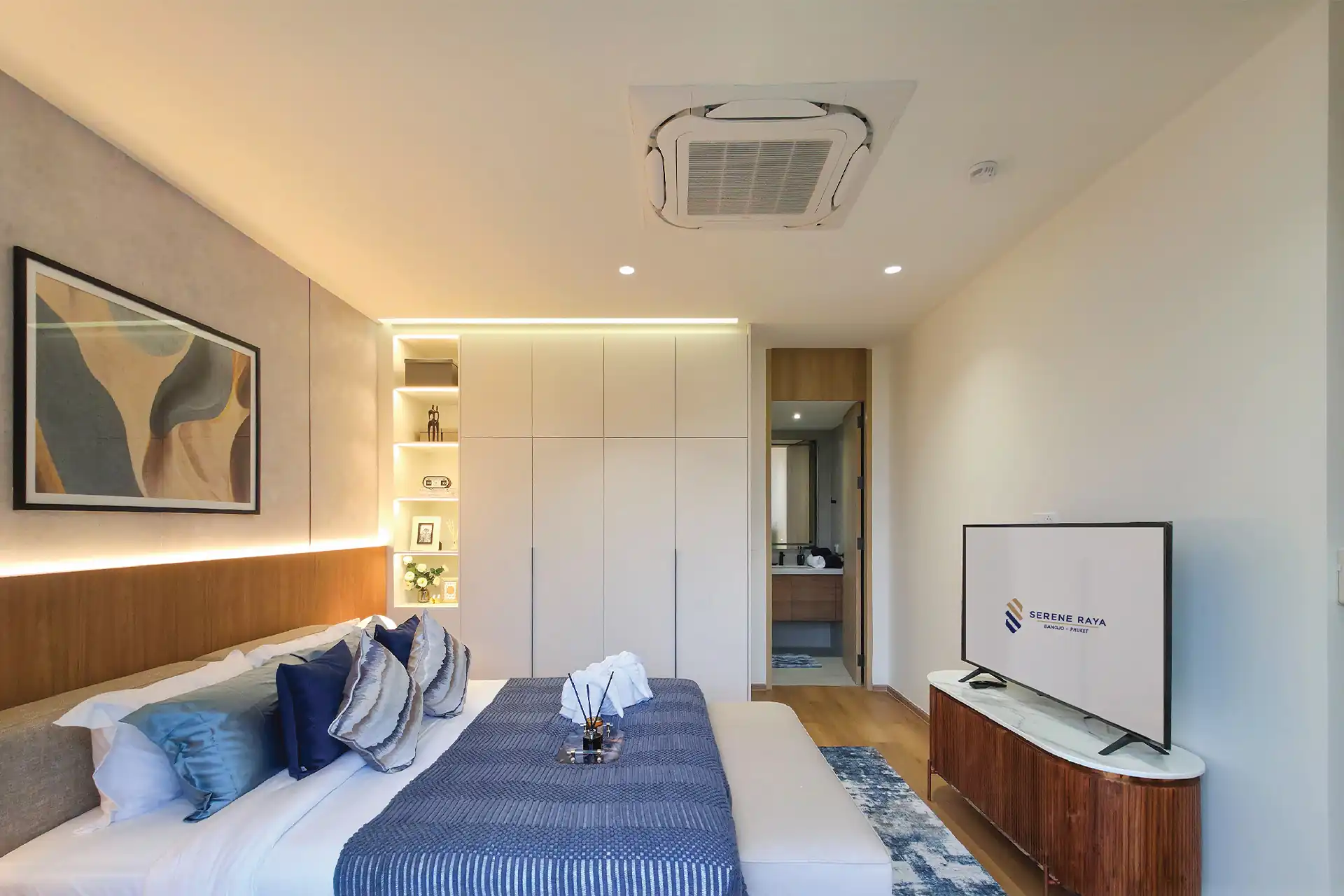 Serene Raya Bangjo stylish upstairs bedroom with blue accents and ensuite