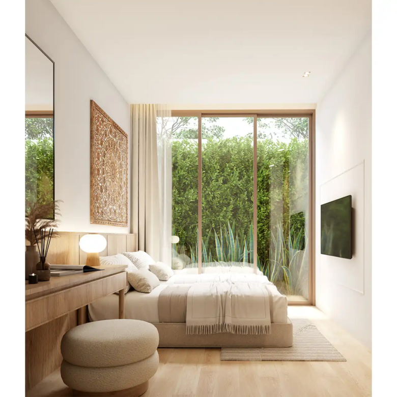 Mono Champaca Pool Villas guest bedroom with garden-facing window wall