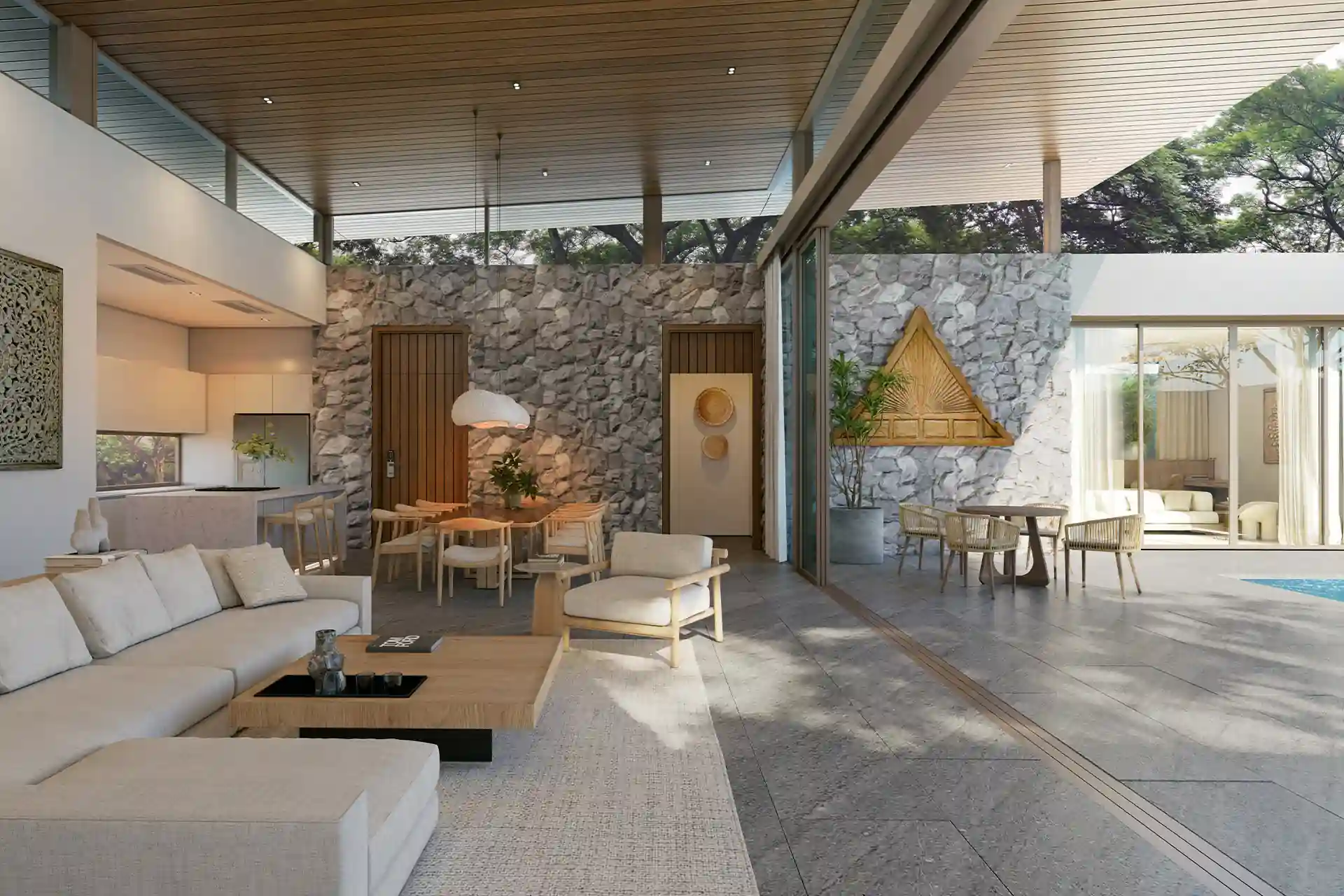 Mono Champaca Pool Villas open living and dining with stone wall