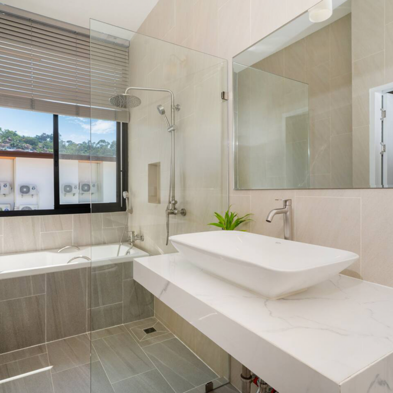 Goldena Twin Kamala bathroom with bathtub, rain shower, and vanity
