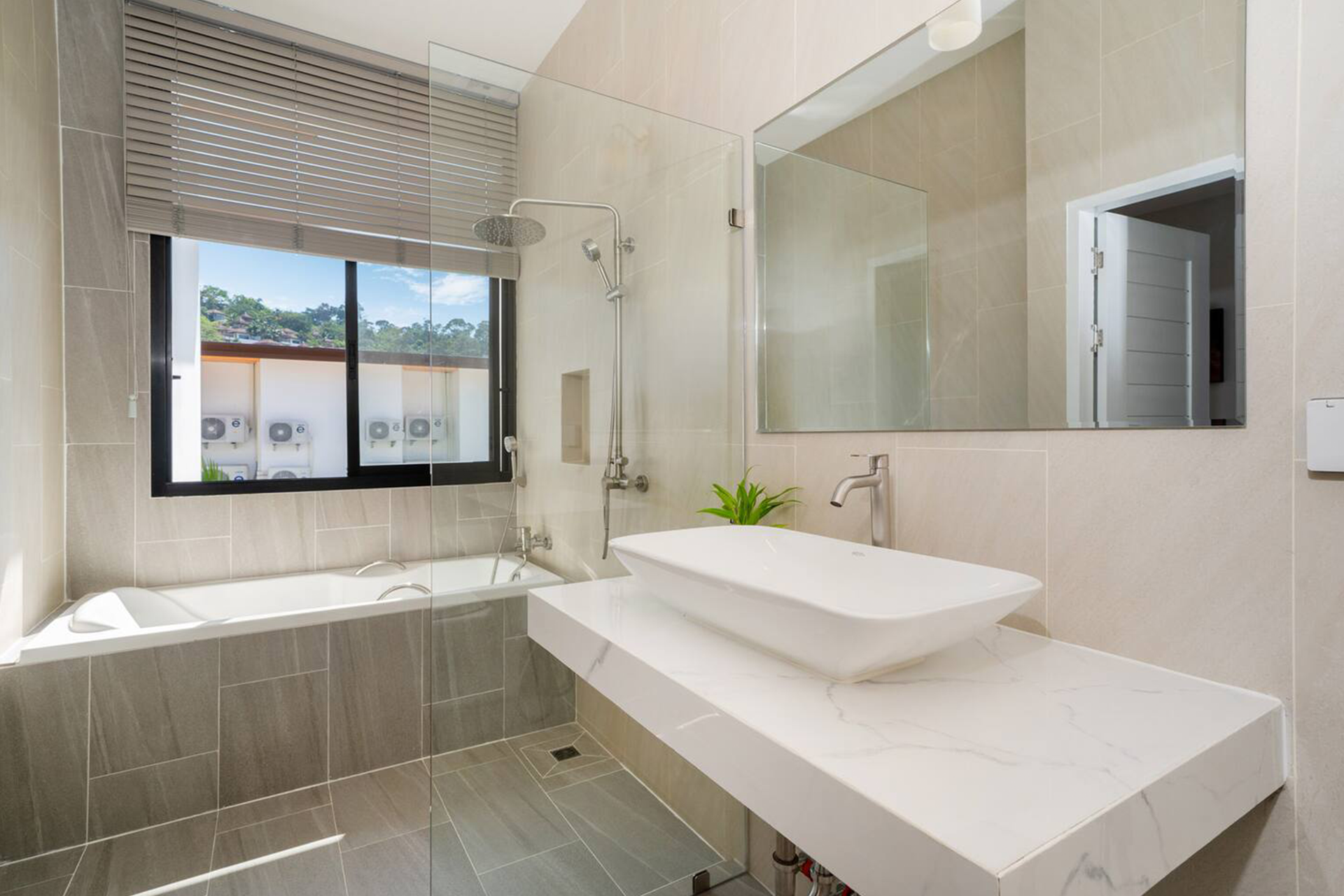 Goldena Twin Kamala bathroom with bathtub, rain shower, and vanity