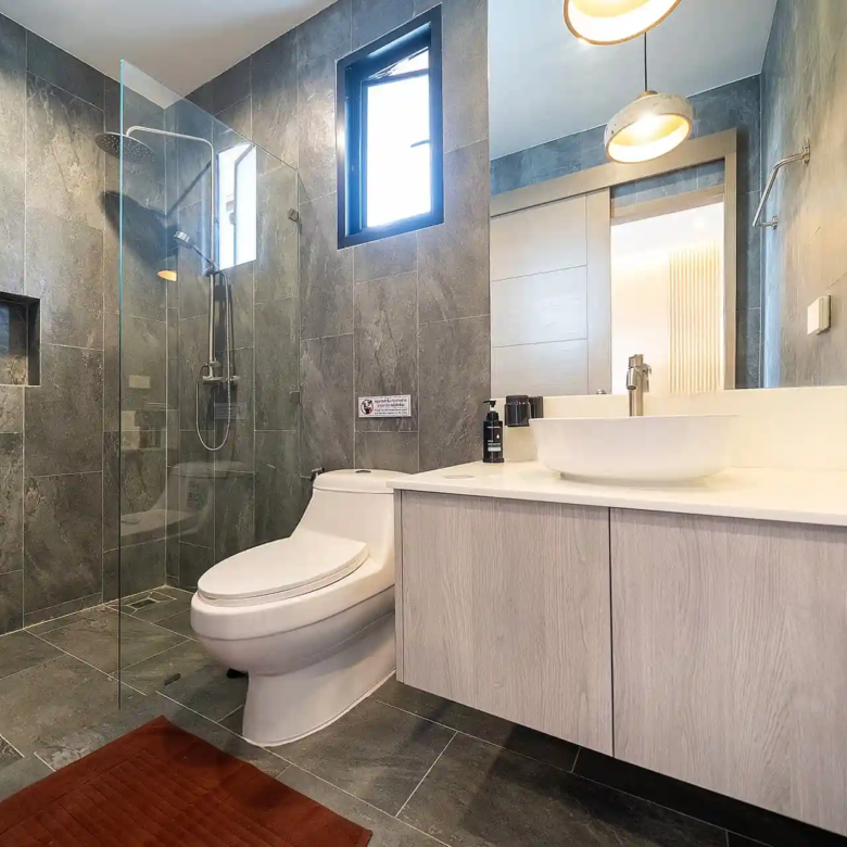 Goldena City Gems Kamala bathroom with walk-in shower and vanity