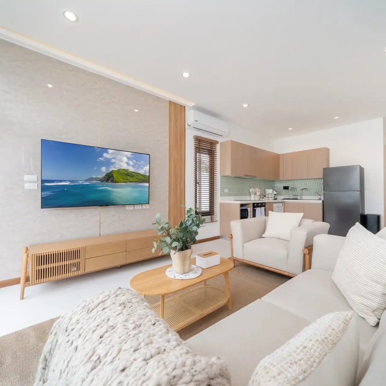 Goldena City Gems Kamala living room with TV and sofa